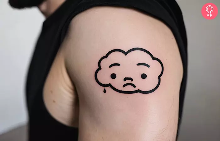 Small sad cloud tattoo on the shoulder