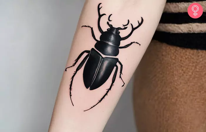 Stag beetle tattoo on the forearm