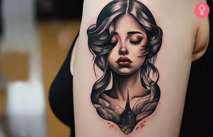 Tattoo of a lonely sad girl on the upper arm