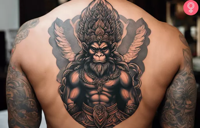 Man with a Thai boxing tattoo on his upper back