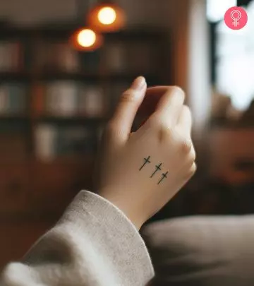 A woman sporting a trinity knot tattoo on the upper arm