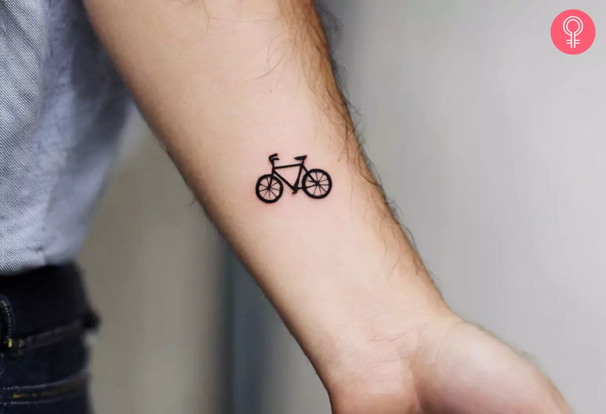 A tiny bicycle tattoo on the arm