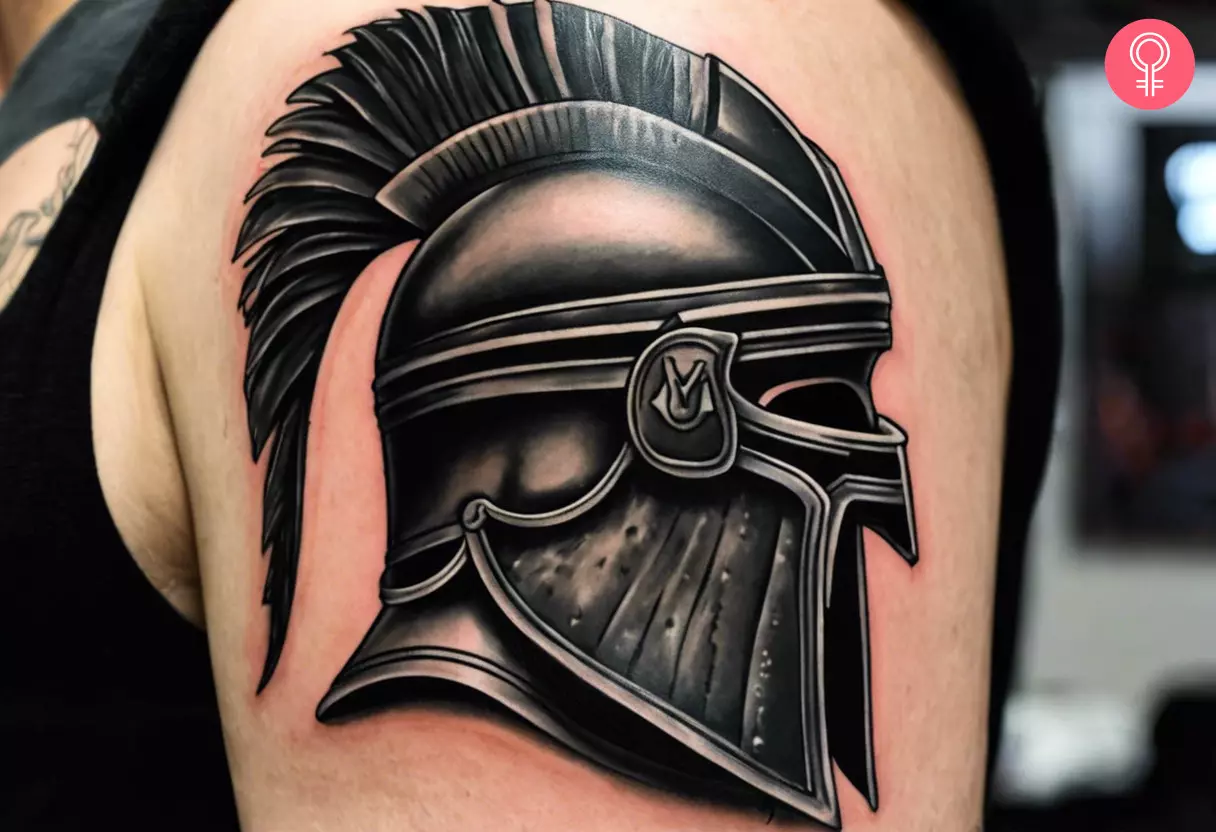 Tattoo of a traditional gladiator helmet on the upper arm