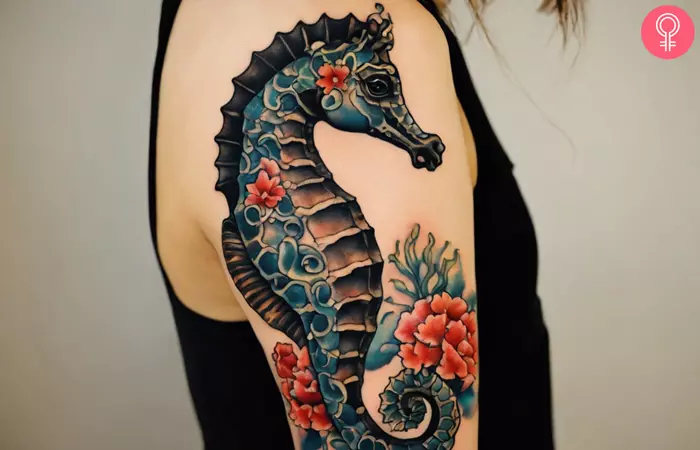 A woman with a traditional-style seahorse tattoo on her upper arm