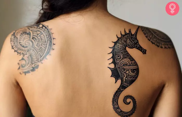 A woman with a tribal seahorse tattoo on her back