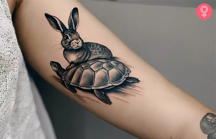A turtle and rabbit tattoo on the arm