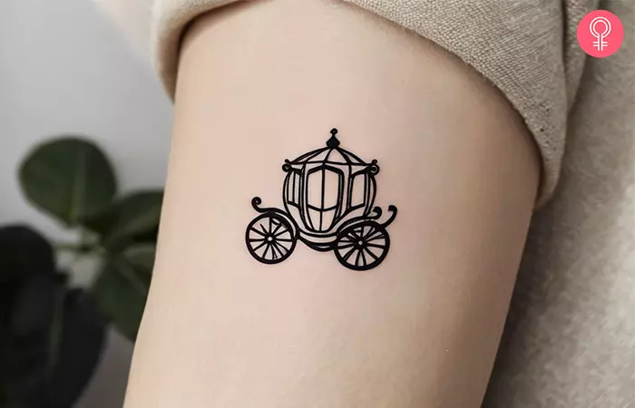 A unique, small Disney tattoo on a woman’s upper arm