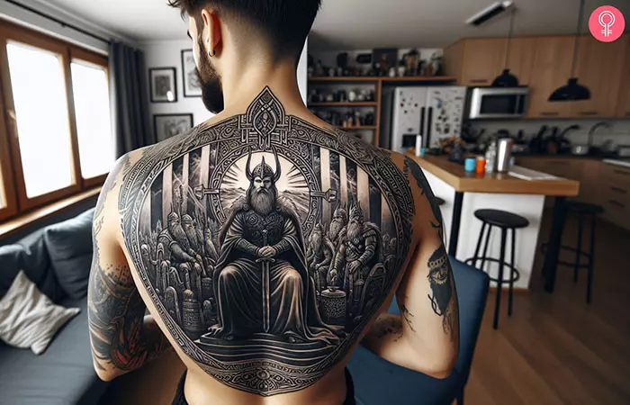 A man with a Valhalla and Odin tattoo on his back