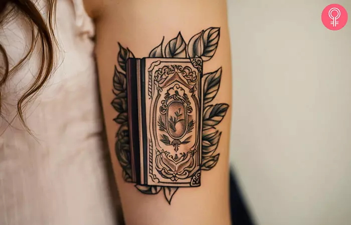 A vintage book tattoo on a woman’s upper arm