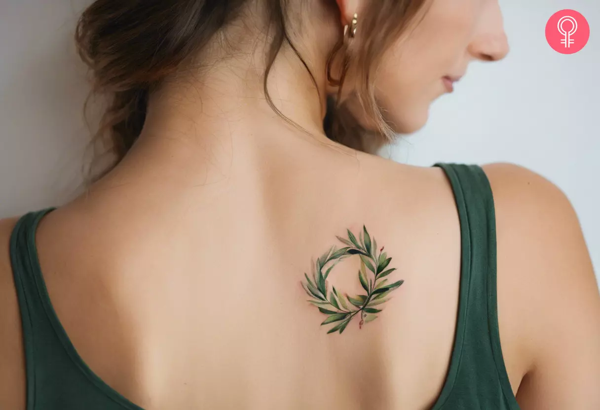 Woman with Greek olive branch tattoo on neck