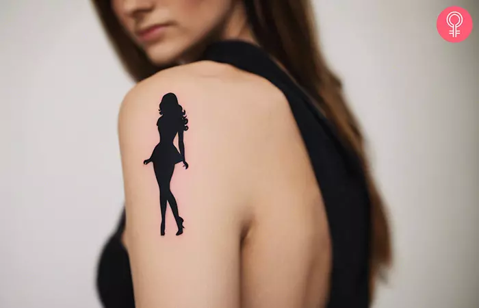 Woman with a Barbie silhouette tattoo on her arm