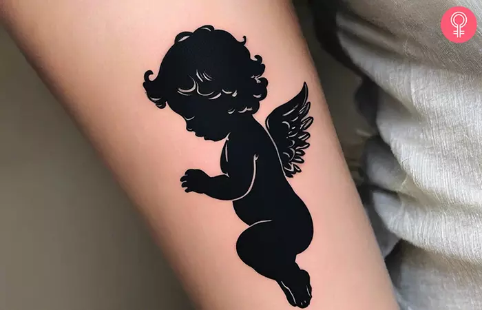 Woman with a baby cherub tattoo