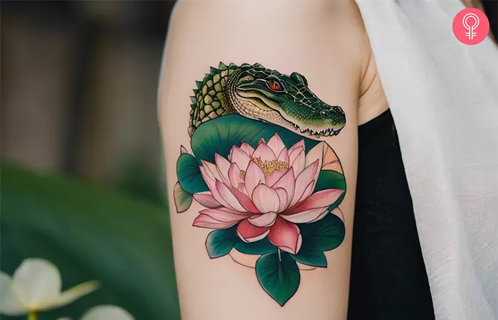 Woman with a crocodile tattoo on the upper arm