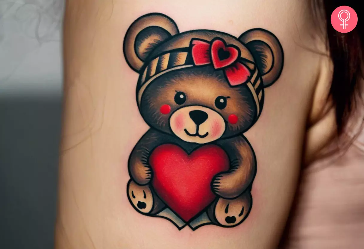 Woman with a heart and teddy bear tattoo on her upper arm