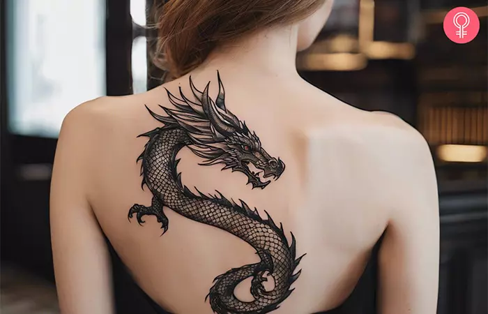 Woman with a male dragon back tattoo
