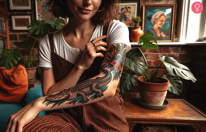 Woman with a neo-traditional crocodile tattoo on the upper arm