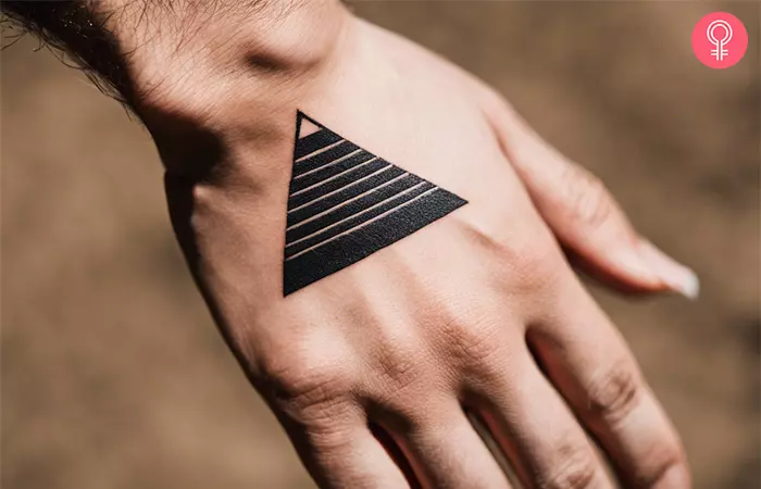 Woman with a pyramid tattoo on the hand