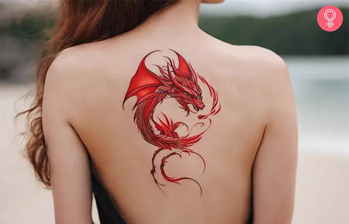 Woman with a red dragon back tattoo