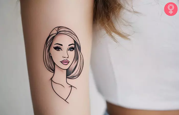 Woman with a simple Barbie tattoo on her arm