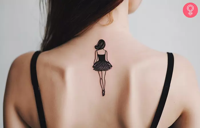 Woman with a small Barbie tattoo on her upper back