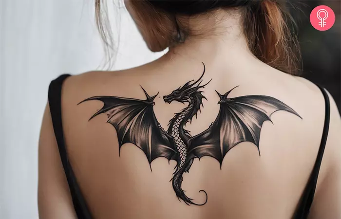 Woman with a traditional dragon back tattoo