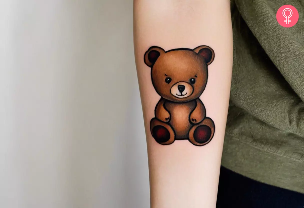 Woman with a traditional teddy bear tattoo on her forearm