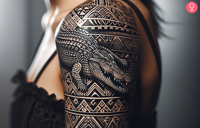 Woman with a tribal crocodile tattoo on the shoulder blade