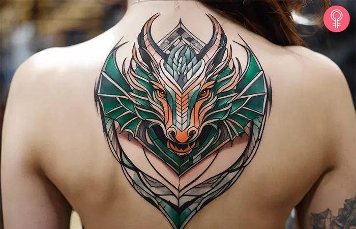Woman with a tribal dragon back tattoo