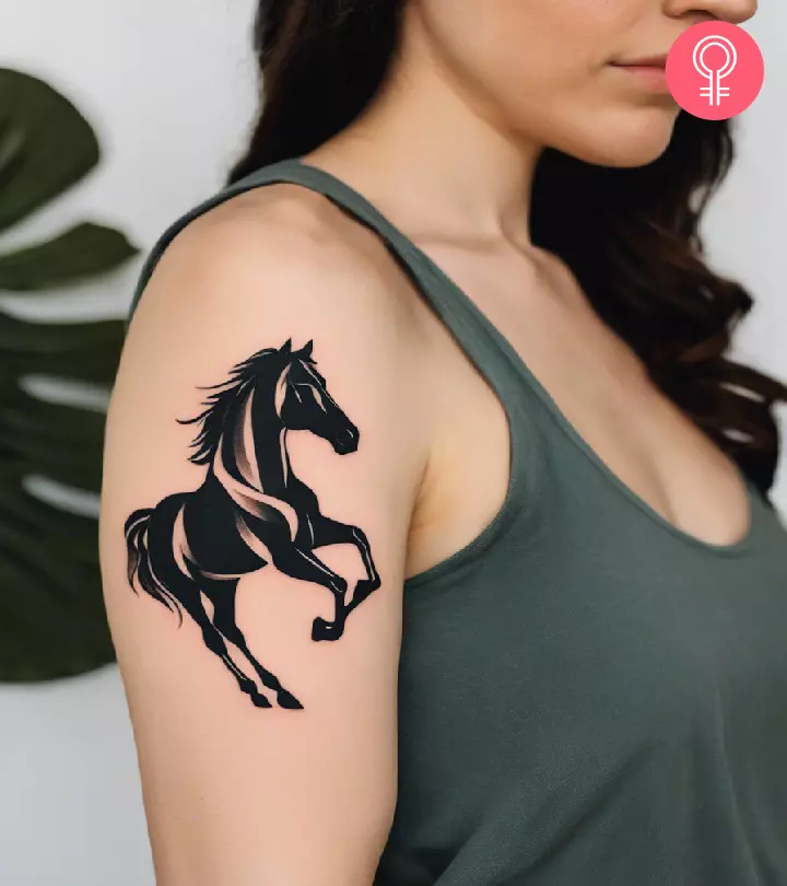 Woman with horse tattoo on her upper arm