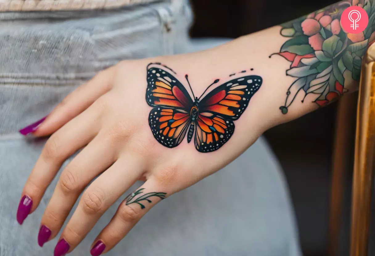 Woman with monarch butterfly hand tattoo