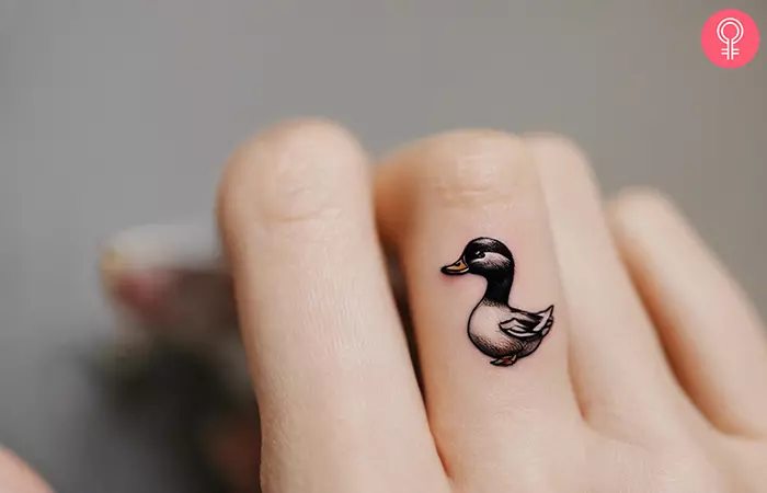 Woman with small duck tattoo on her finger