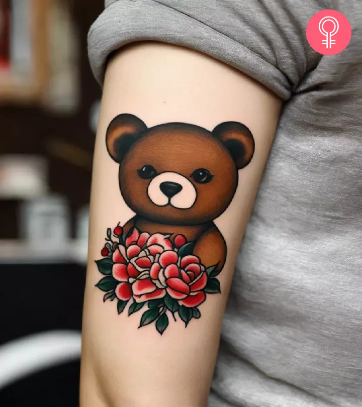 Woman with teddy bear tattoo on her upper arm
