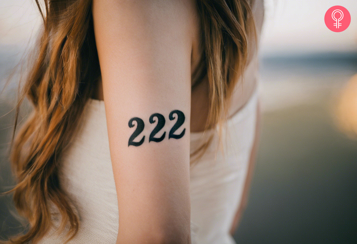 A 222 angel number tattoo on a woman’s arm
