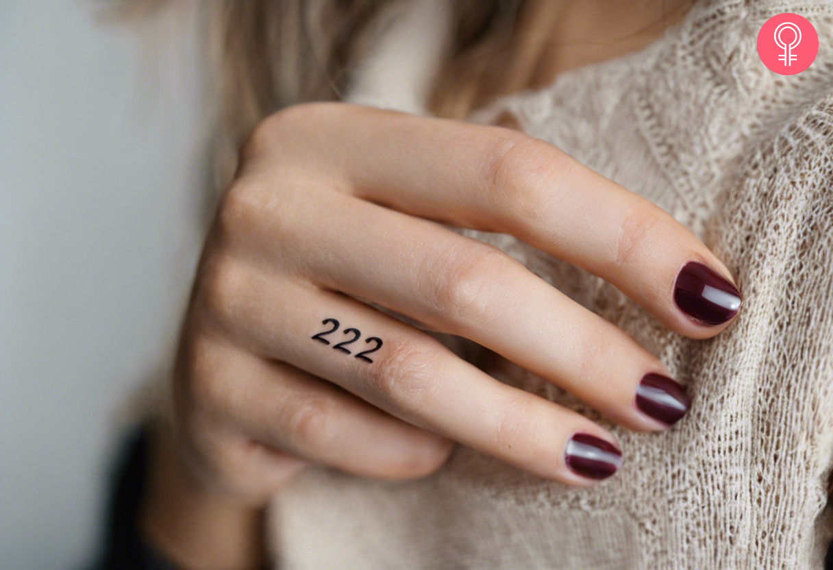 A 222 tattoo on a woman’s finger