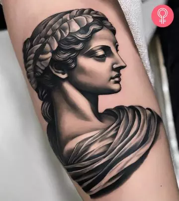 A gargoyle tattoo design on the arm of a woman