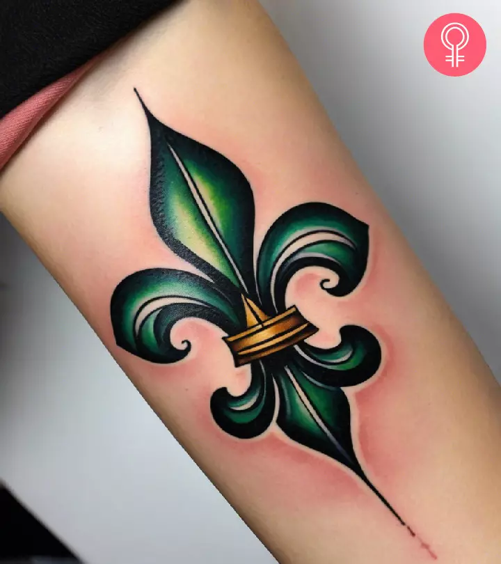A fleur de lis tattoo on the forearm