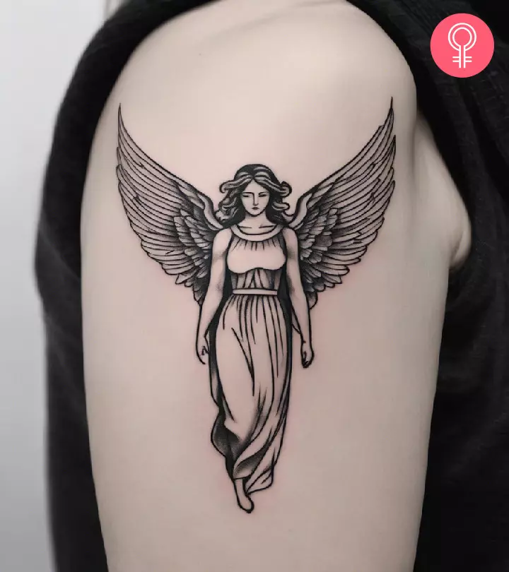 Woman with a guardian angel tattoo on the upper arm