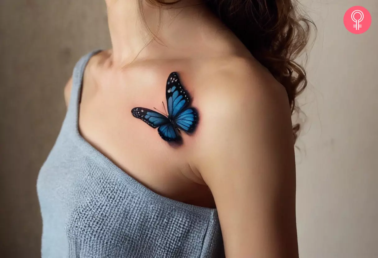 A 3D blue butterfly tattoo under the collarbone