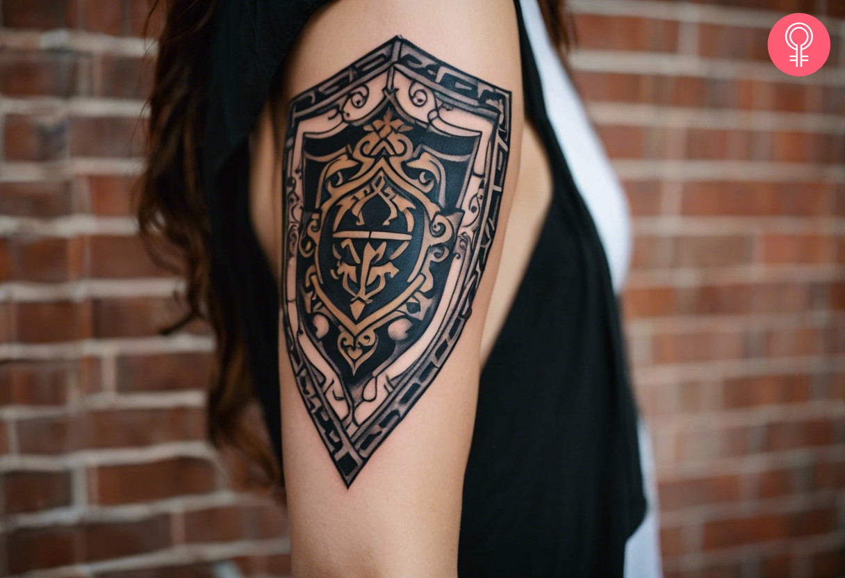 A Hylian shield tattoo on the upper arm of a woman