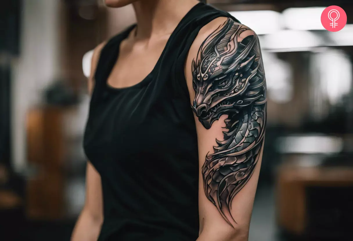 A biomechanical dragon tattoo on the upper arm