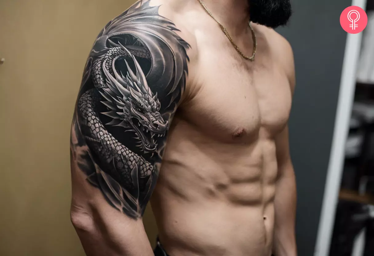 A black and gray dragon tattoo on the bicep