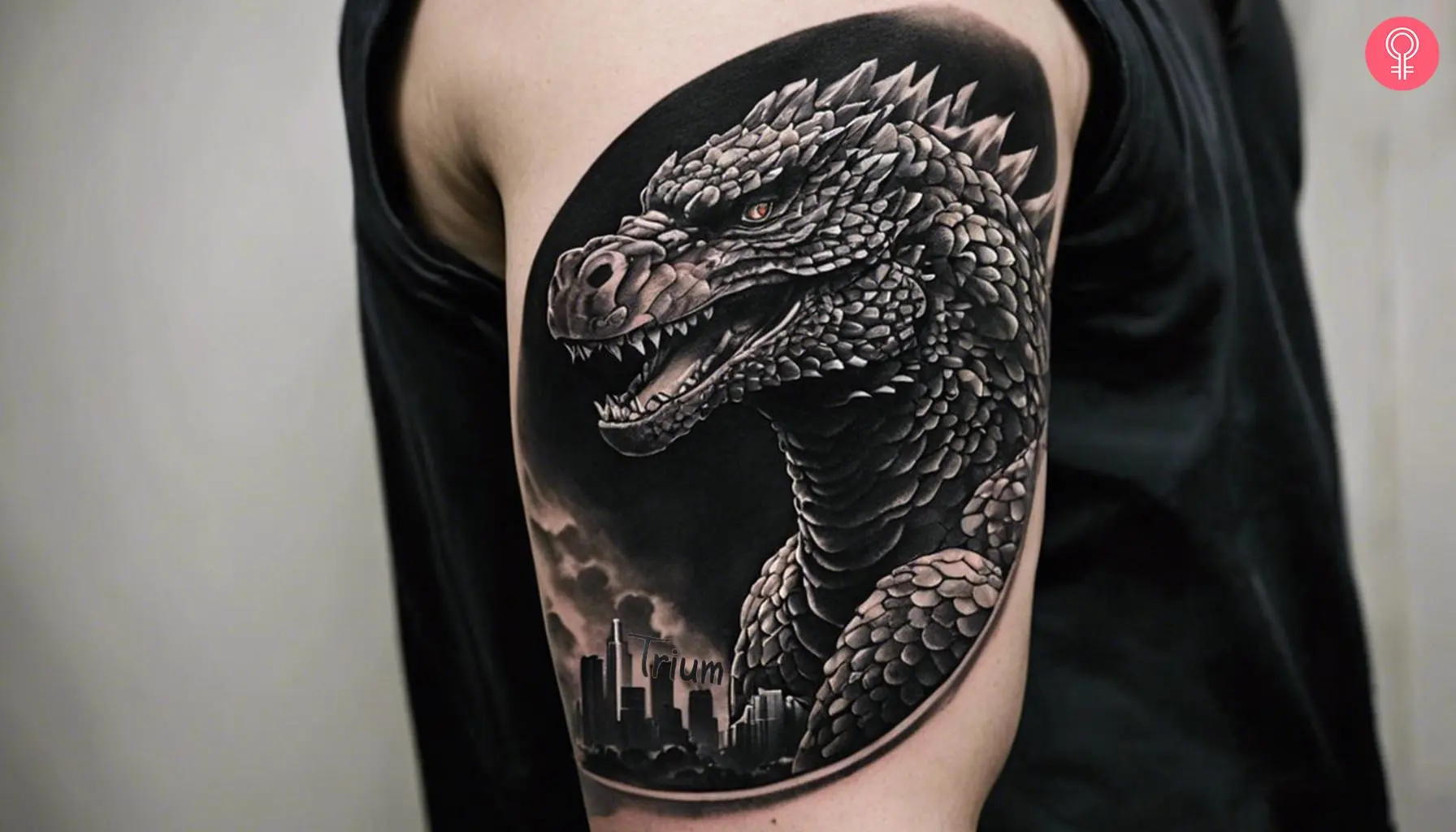 A black and white Godzilla tattoo design on a man’s upper arm