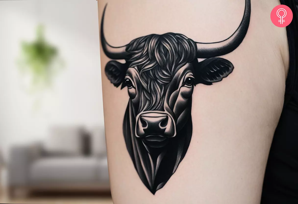 A black bull tattoo on the arm