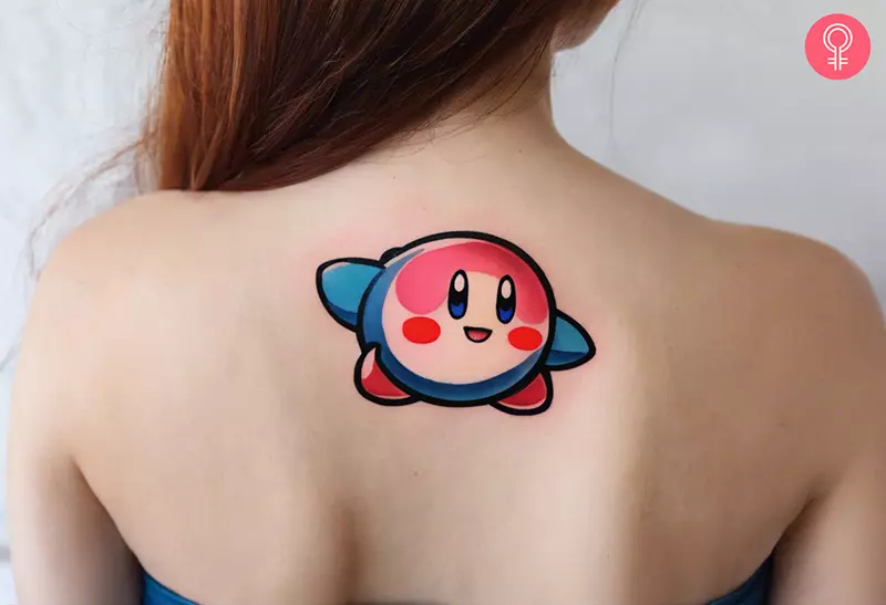 A blue and pink Kirby tattoo on the upper back