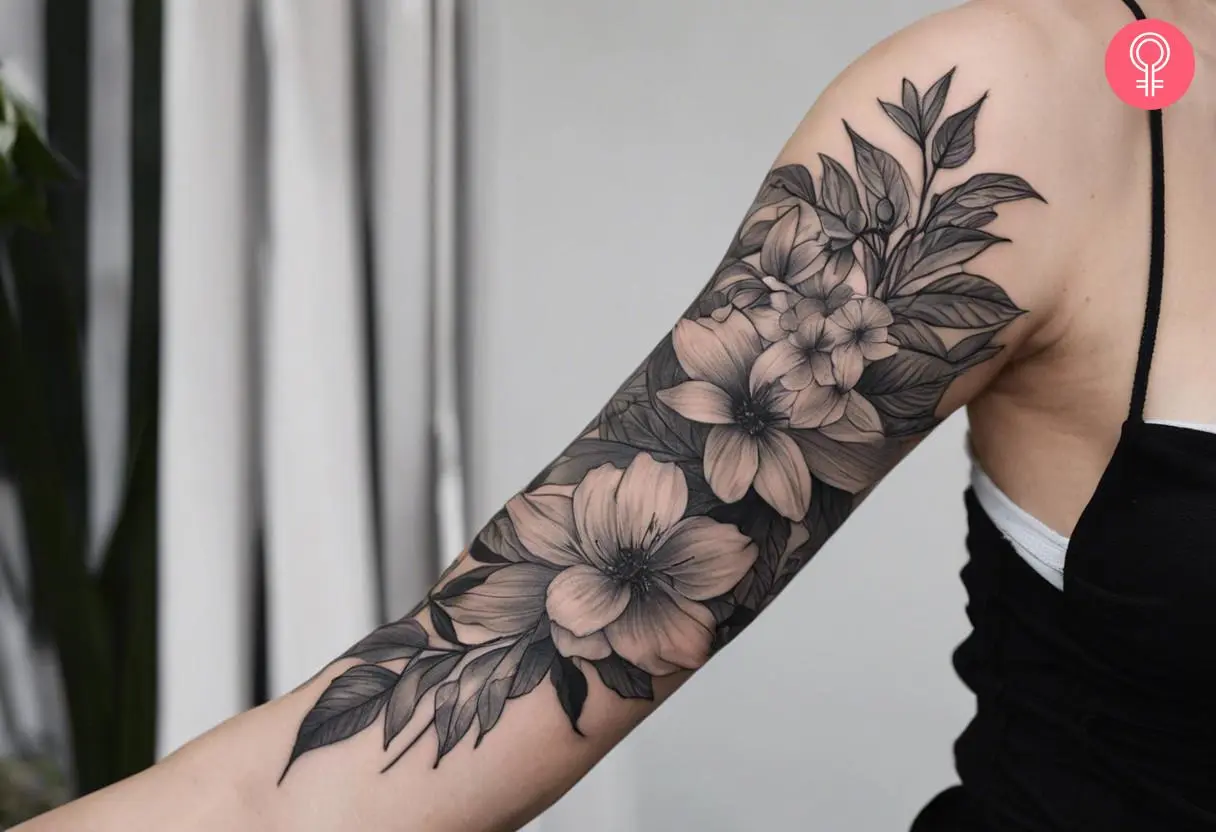 A botanical half-sleeve tattoo on the upper arm