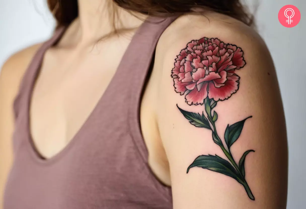 A carnation flower tattoo on a woman’s arm