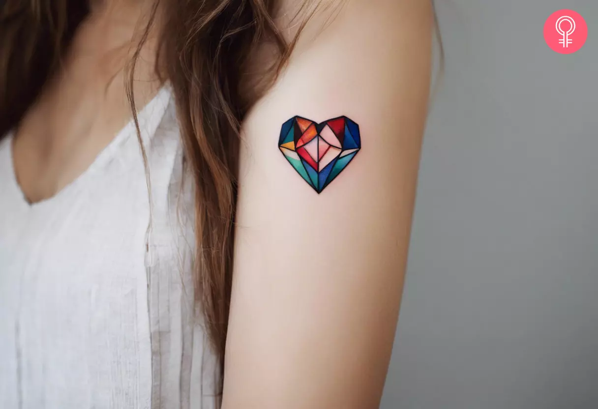 A crystal heart tattoo on the upper arm