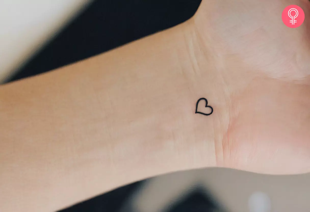 A dainty heart tattoo on the wrist