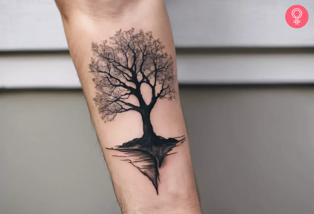 A dead tree tattoo on the forearm