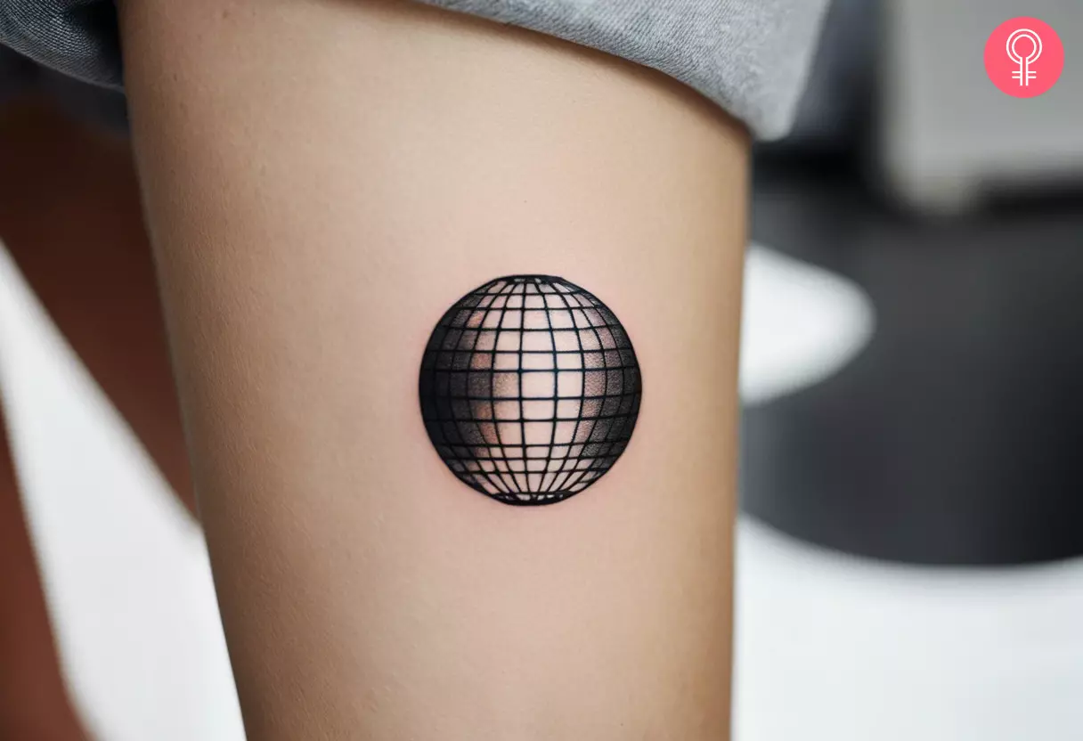 A flash disco ball tattoo on the arm